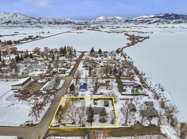 snowy aerial view with a mountain view