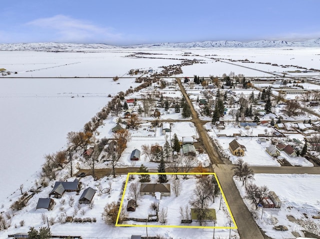 snowy aerial view with a mountain view