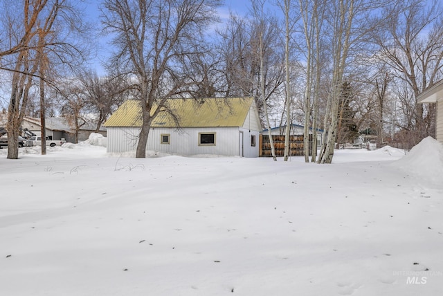 snow covered house with an outdoor structure