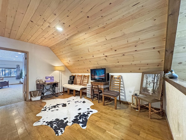 sitting room featuring vaulted ceiling, wooden ceiling, and light hardwood / wood-style flooring