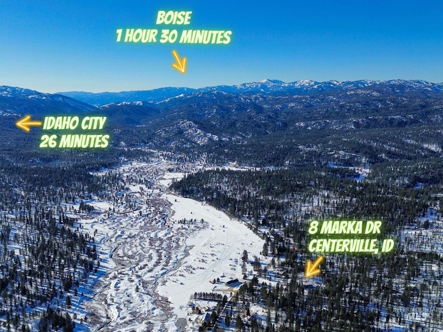 snowy aerial view featuring a mountain view