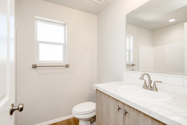 1468 N Coltsfoot Ave, Kuna, ID 83634 - bathroom with vanity, toilet, healthy amount of natural light, and wood finished floors