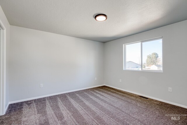 1468 N Coltsfoot Ave, Kuna, ID 83634 - carpeted empty room with baseboards and a textured ceiling