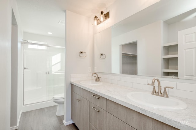 1468 N Coltsfoot Ave, Kuna, ID 83634 - bathroom featuring toilet, decorative backsplash, a stall shower, and double vanity