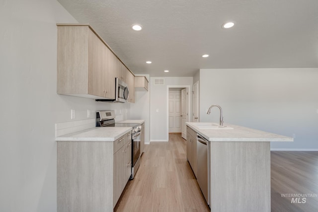 1468 N Coltsfoot Ave, Kuna, ID 83634 - kitchen featuring appliances with stainless steel finishes, a sink, modern cabinets, light brown cabinets, and light countertops