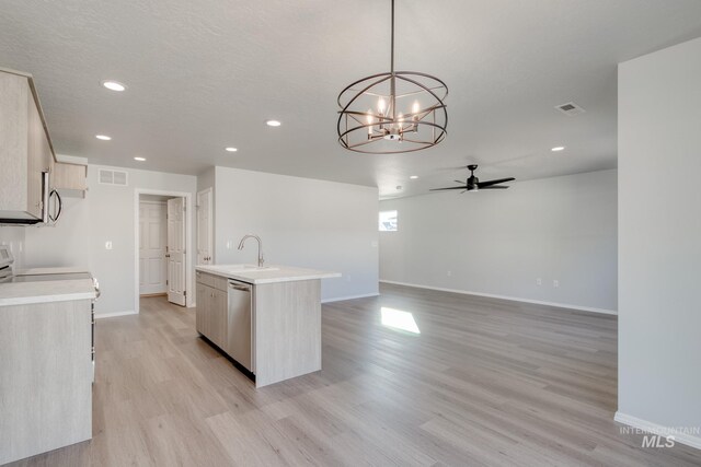 1468 N Coltsfoot Ave, Kuna, ID 83634 - kitchen featuring dishwasher, a ceiling fan, baseboards, light wood finished floors, and light countertops