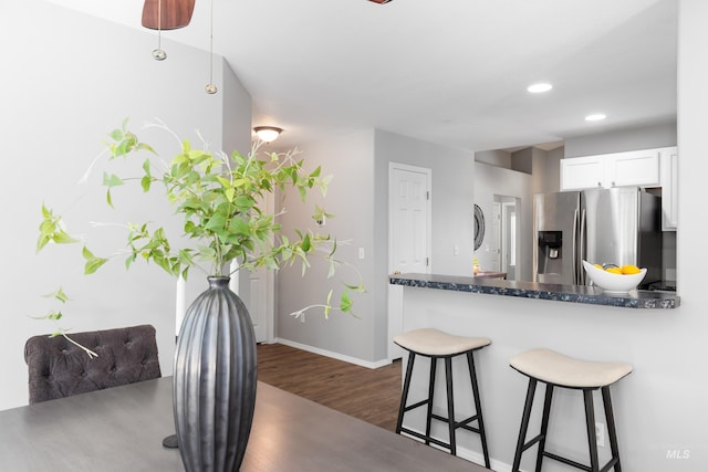 11031 W Red Maple Dr, Boise, ID 83709 - kitchen featuring stainless steel fridge with ice dispenser, a kitchen breakfast bar, dark wood-style floors, white cabinetry, and recessed lighting