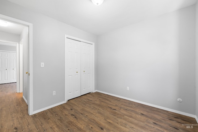 11031 W Red Maple Dr, Boise, ID 83709 - unfurnished bedroom with dark wood-style flooring and a closet