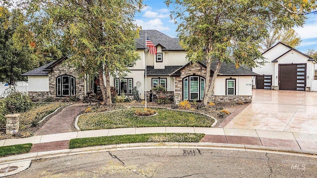 3136 S Bear Claw Way, Meridian, ID 83642 - view of front of home featuring stucco siding, stone siding, concrete driveway, a shingled roof, and an outdoor structure