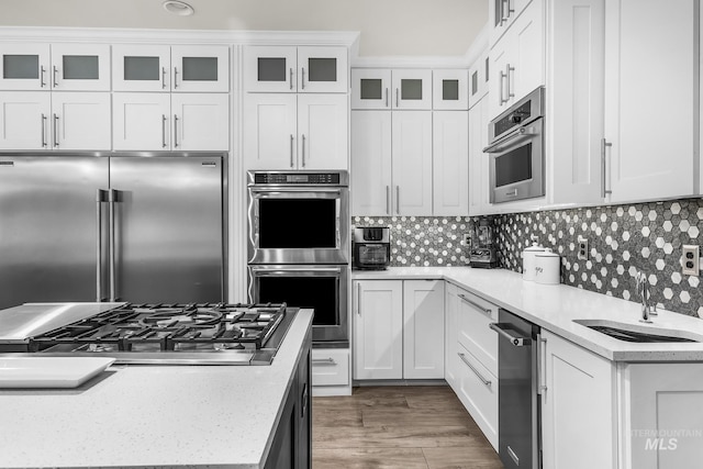 3136 S Bear Claw Way, Meridian, ID 83642 - kitchen featuring stainless steel appliances, a sink, white cabinetry, and backsplash
