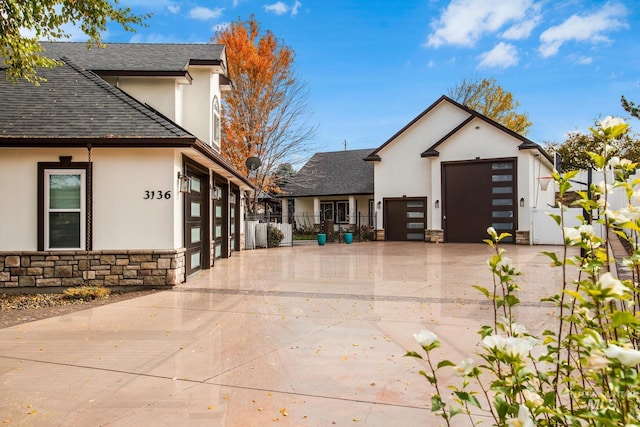 3136 S Bear Claw Way, Meridian, ID 83642 - view of home's exterior featuring stucco siding, stone siding, roof with shingles, and driveway