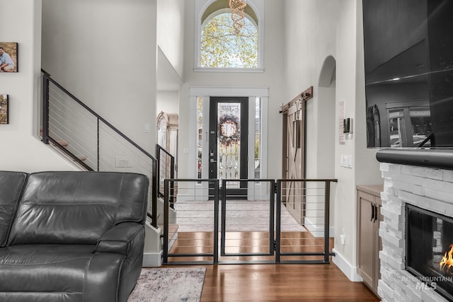 3136 S Bear Claw Way, Meridian, ID 83642 - entryway with a towering ceiling, stairway, wood finished floors, a fireplace, and baseboards