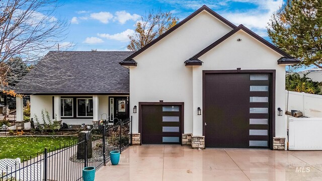 3136 S Bear Claw Way, Meridian, ID 83642 - view of front of house with a shingled roof, driveway, stucco siding, stone siding, and an attached garage