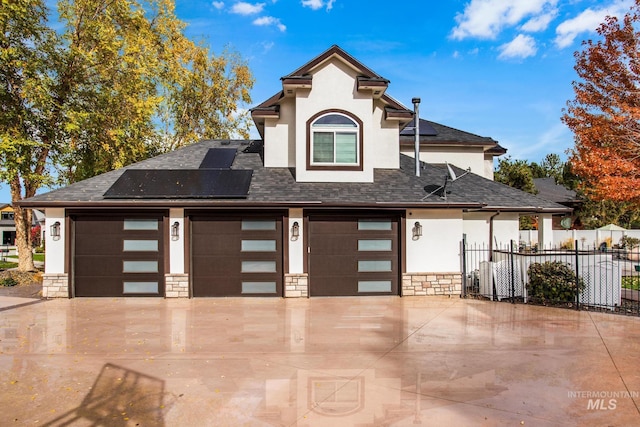 3136 S Bear Claw Way, Meridian, ID 83642 - view of front of home with stucco siding, solar panels, stone siding, and roof with shingles