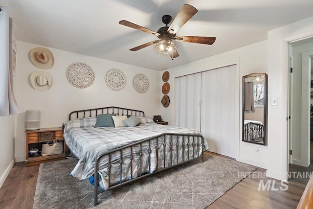 bedroom featuring ceiling fan and dark wood-type flooring