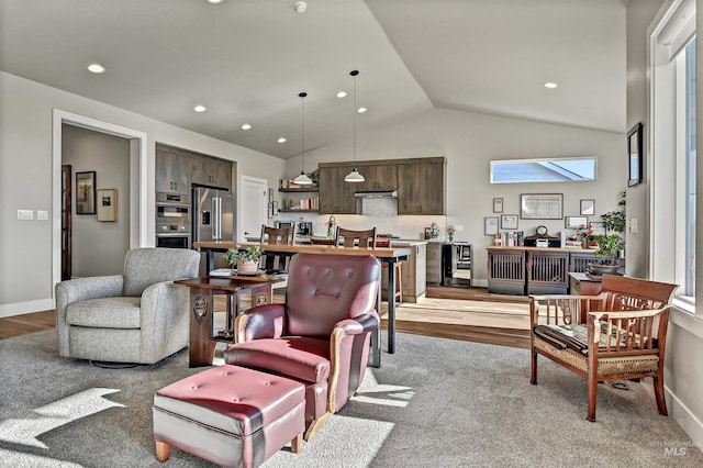 living room with vaulted ceiling, wine cooler, and light wood-type flooring