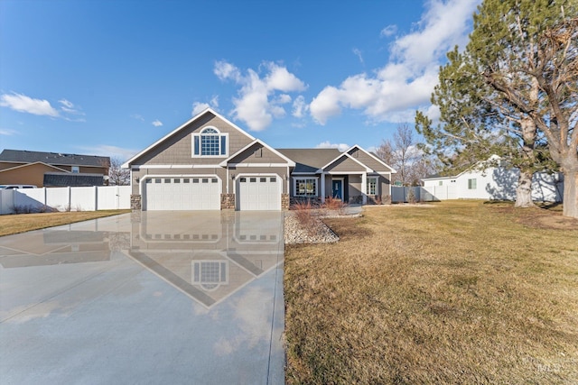 view of front of property with driveway, a garage, fence, and a front lawn