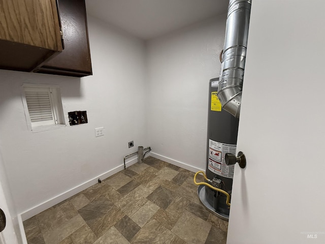 laundry area with baseboards, gas water heater, washer hookup, stone finish floor, and hookup for an electric dryer