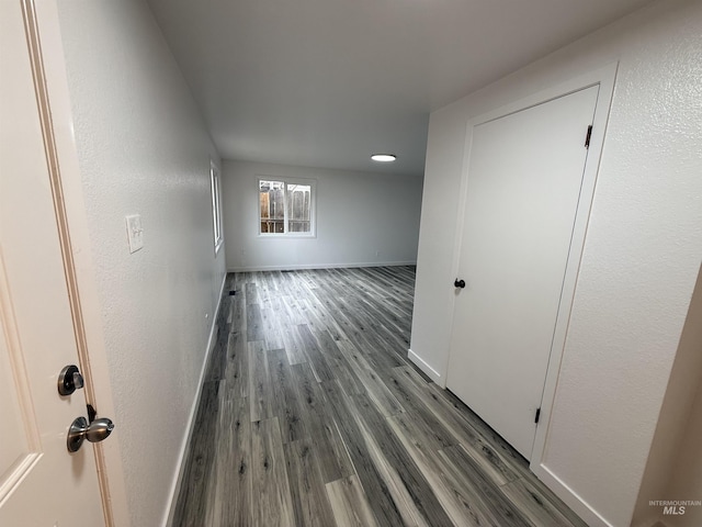 interior space with baseboards and wood finished floors