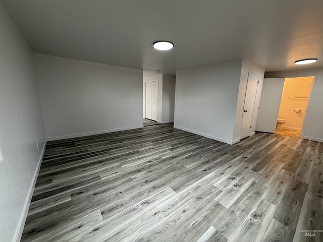 spare room with wood finished floors and baseboards