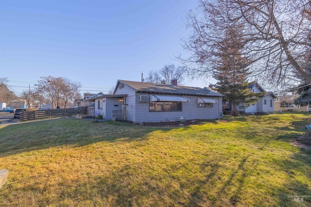 view of side of home with a lawn