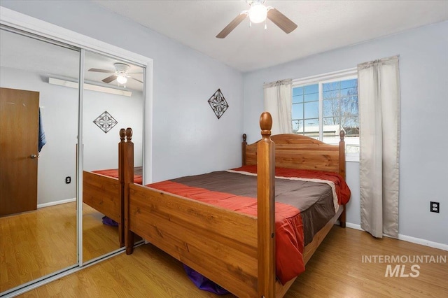 bedroom with ceiling fan, a closet, baseboards, and wood finished floors