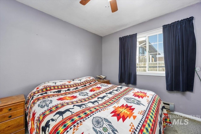 carpeted bedroom featuring visible vents, baseboards, and a ceiling fan