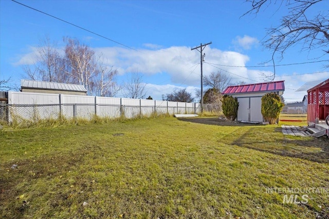 view of yard with a fenced backyard, a shed, and an outdoor structure