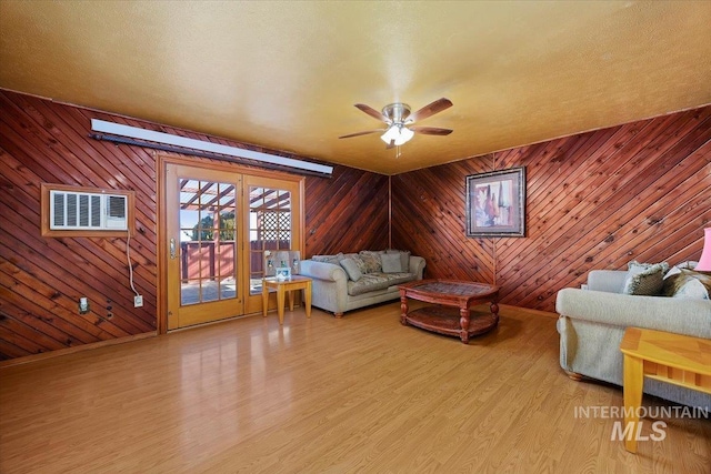 unfurnished living room featuring ceiling fan, wood finished floors, visible vents, and baseboards