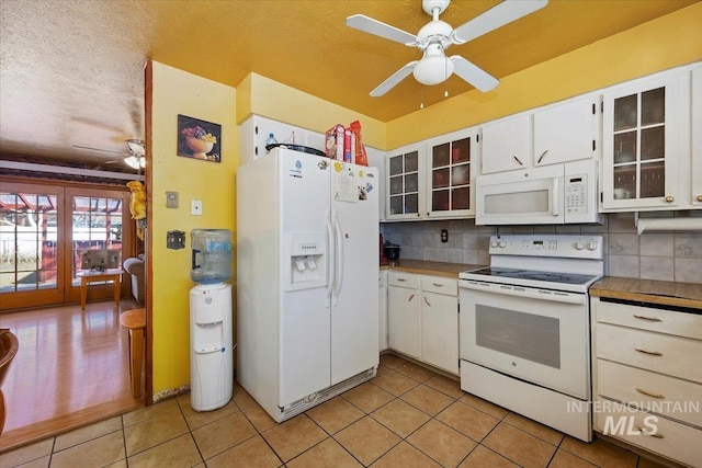 kitchen with white appliances, decorative backsplash, a ceiling fan, and light tile patterned flooring