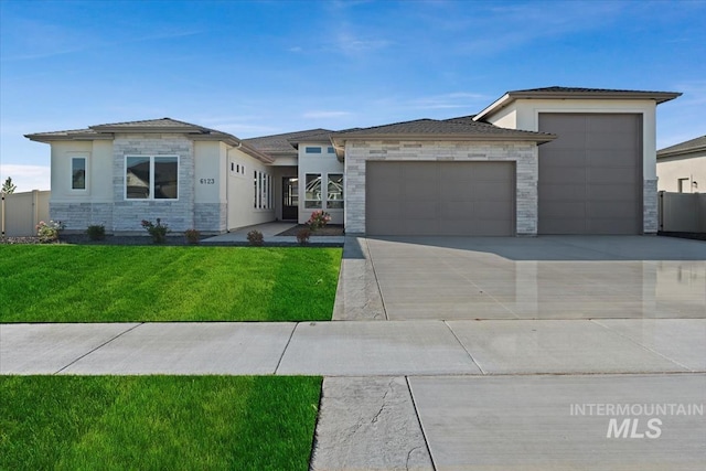 view of front of house featuring a garage and a front yard