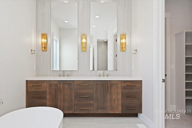 bathroom with vanity and a tub