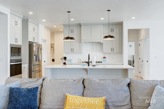 3661 S Corabell Way, Meridian, ID 83642 - kitchen featuring open floor plan, stainless steel appliances, light countertops, a sink, and backsplash