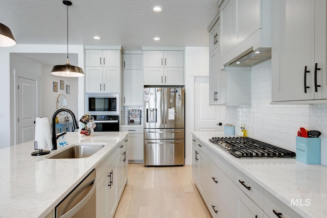 3661 S Corabell Way, Meridian, ID 83642 - kitchen with stainless steel appliances, a sink, recessed lighting, light stone counters, and pendant lighting