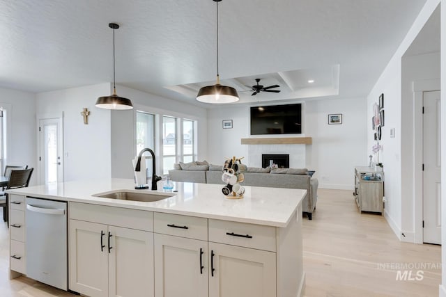 3661 S Corabell Way, Meridian, ID 83642 - kitchen with a sink, dishwasher, ceiling fan, a fireplace, and light wood-style floors