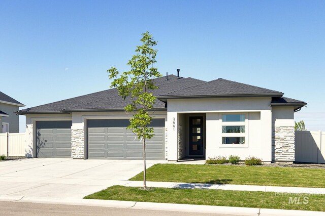3661 S Corabell Way, Meridian, ID 83642 - prairie-style home with stone siding, an attached garage, driveway, stucco siding, and roof with shingles