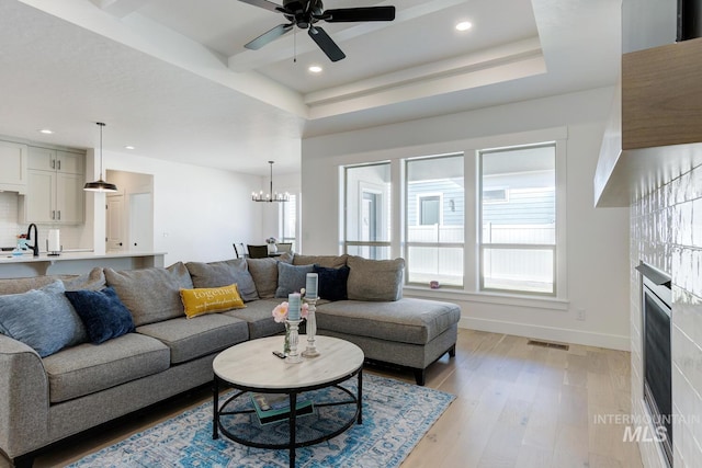 3661 S Corabell Way, Meridian, ID 83642 - living area with light wood finished floors, a chandelier, recessed lighting, ceiling fan, and baseboards
