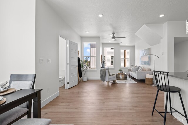 509 E Violets Cove Ln, Garden City, ID 83714 - living room featuring baseboards, ceiling fan, a textured ceiling, recessed lighting, and light wood finished floors