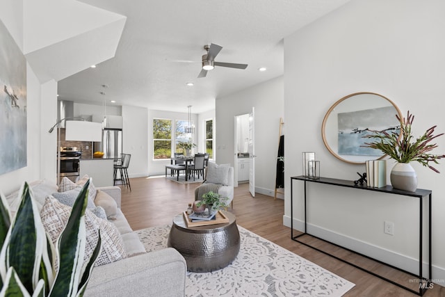 509 E Violets Cove Ln, Garden City, ID 83714 - living room with recessed lighting, a ceiling fan, light wood-style floors, and baseboards