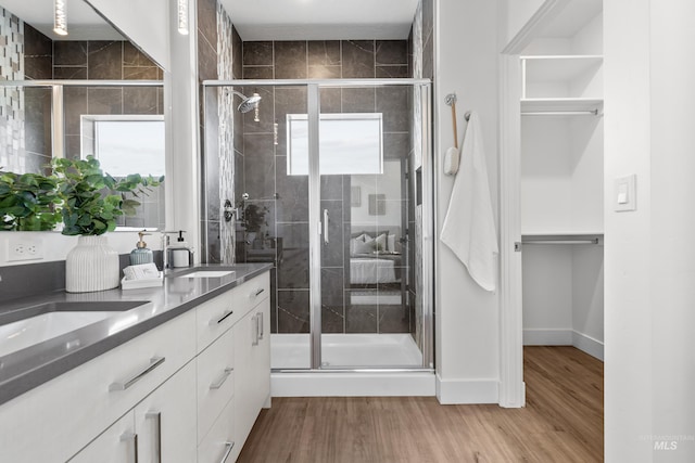 509 E Violets Cove Ln, Garden City, ID 83714 - full bath featuring double vanity, a sink, a stall shower, and wood finished floors