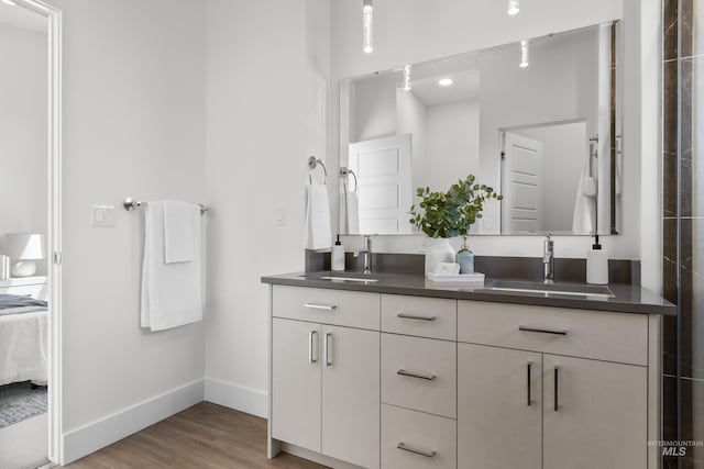 509 E Violets Cove Ln, Garden City, ID 83714 - full bathroom with a sink, ensuite bathroom, double vanity, and wood finished floors