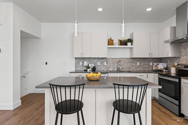 509 E Violets Cove Ln, Garden City, ID 83714 - kitchen featuring wall chimney range hood, open shelves, dark countertops, stainless steel range with electric cooktop, and a sink