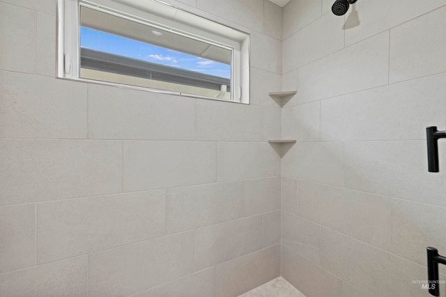 bathroom with tiled shower