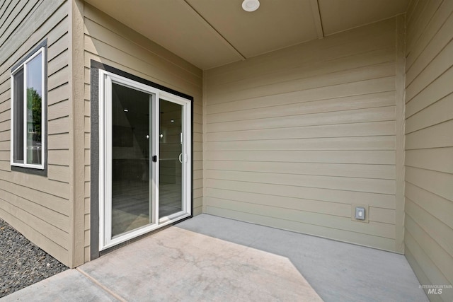 doorway to property with a patio