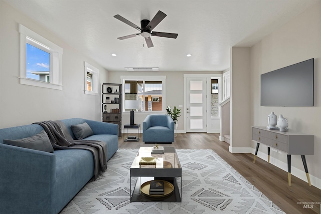 living room with ceiling fan and wood-type flooring