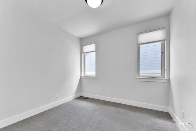 2499 E Berghan Ln, Meridian, ID 83642 - empty room featuring baseboards and dark colored carpet