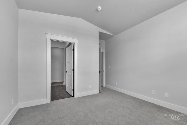 2499 E Berghan Ln, Meridian, ID 83642 - unfurnished bedroom featuring carpet floors, vaulted ceiling, baseboards, and a spacious closet