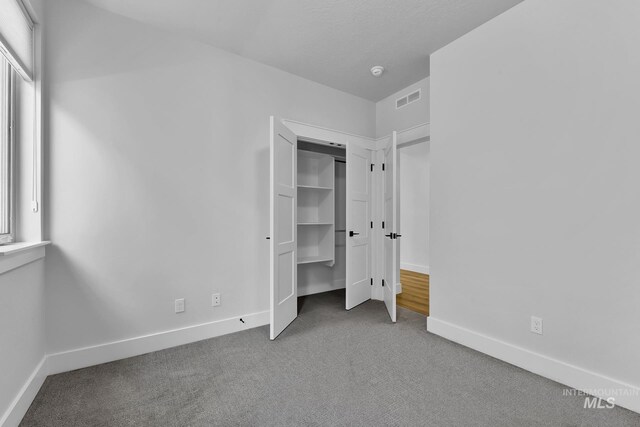 2499 E Berghan Ln, Meridian, ID 83642 - unfurnished bedroom featuring carpet, multiple windows, and baseboards