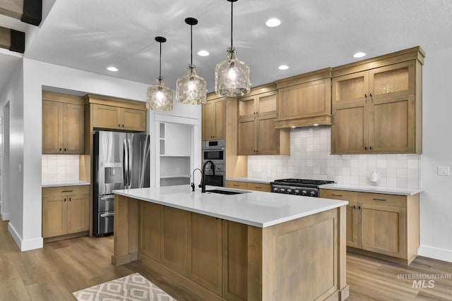 2499 E Berghan Ln, Meridian, ID 83642 - kitchen featuring appliances with stainless steel finishes, a sink, light wood finished floors, backsplash, and recessed lighting