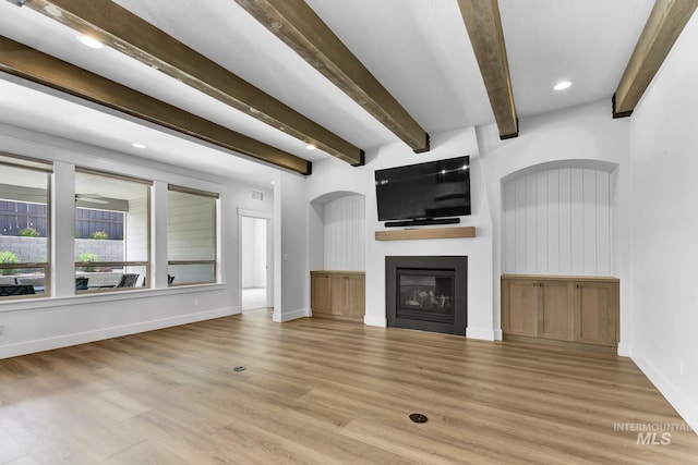 2499 E Berghan Ln, Meridian, ID 83642 - unfurnished living room featuring beam ceiling, wood finished floors, a large fireplace, baseboards, and recessed lighting